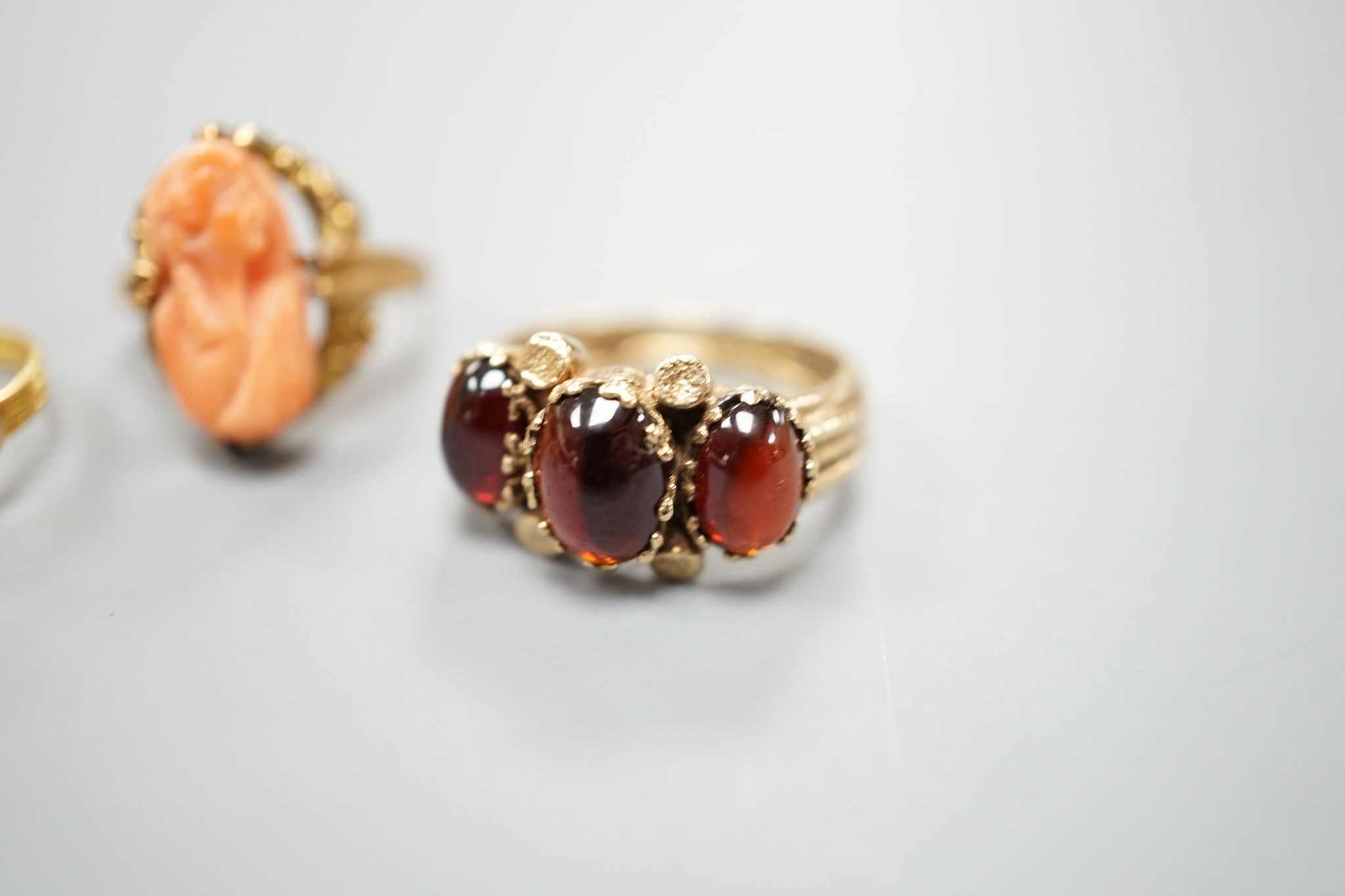 Three assorted modern 9ct gold and gem set ring including turquoise and seed pearl, gross 11.2 grams, a 10k and coral set ring, gross 2.7 grams and a yellow metal and turquoise set ring, gross 1.3 grams.